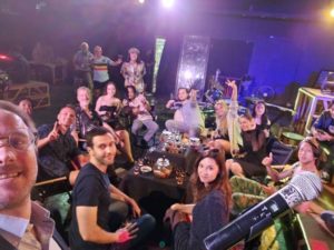 TV set with actors performing under bright lights, capturing the city’s vibrant industry.  

