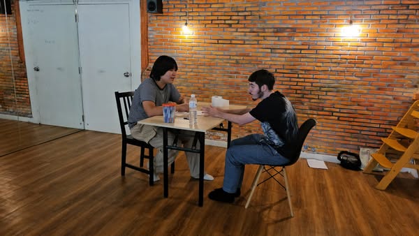 Lead actor delivering a dramatic performance on a Bangkok set, highlighting talent.