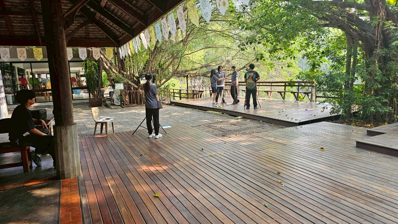 Multicultural cast rehearsing on a Bangkok film set, highlighting professionalism.