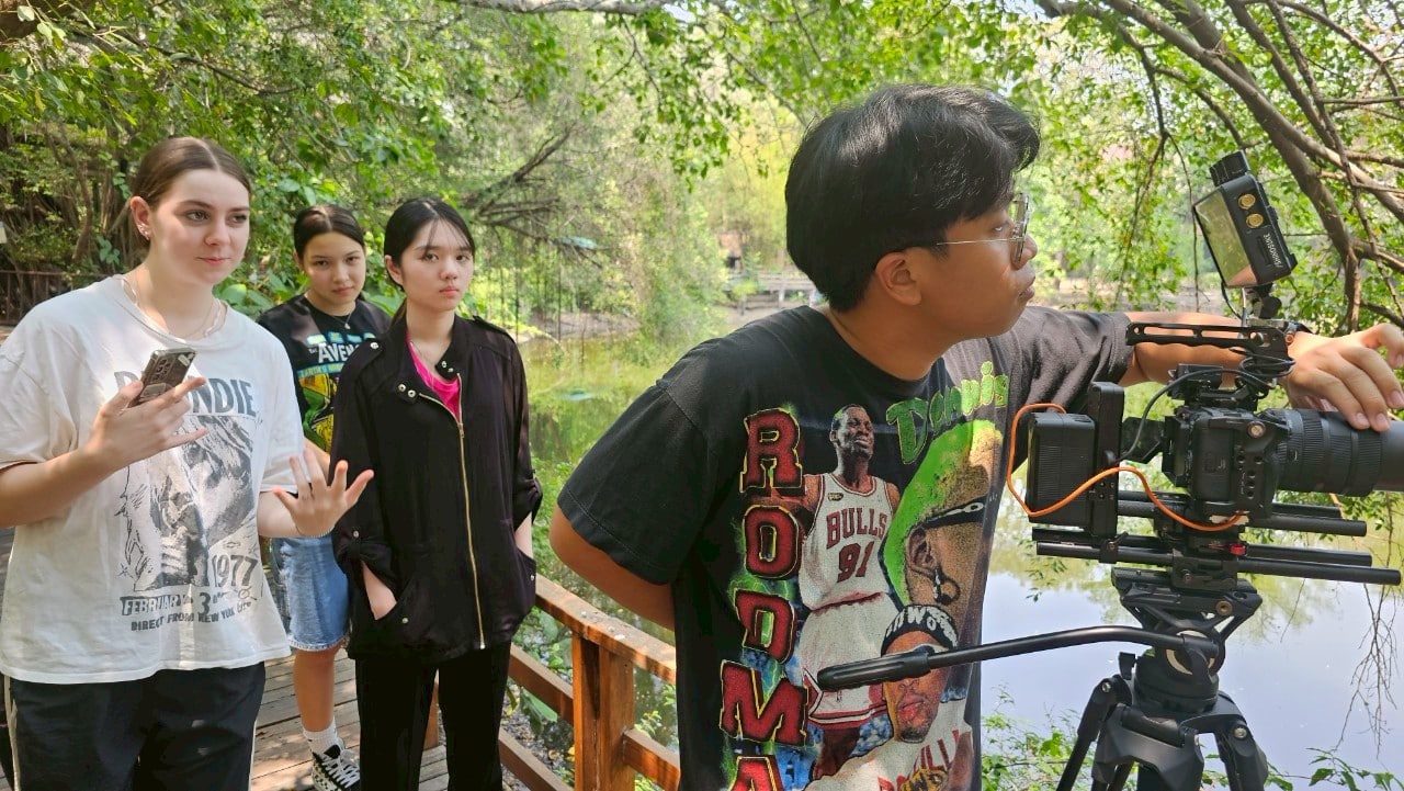 Thai model posing confidently on a Thailand ad set, highlighting talent.