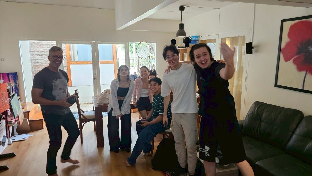 Diverse group of foreign models posing on a Bangkok ad set, showcasing global talent.